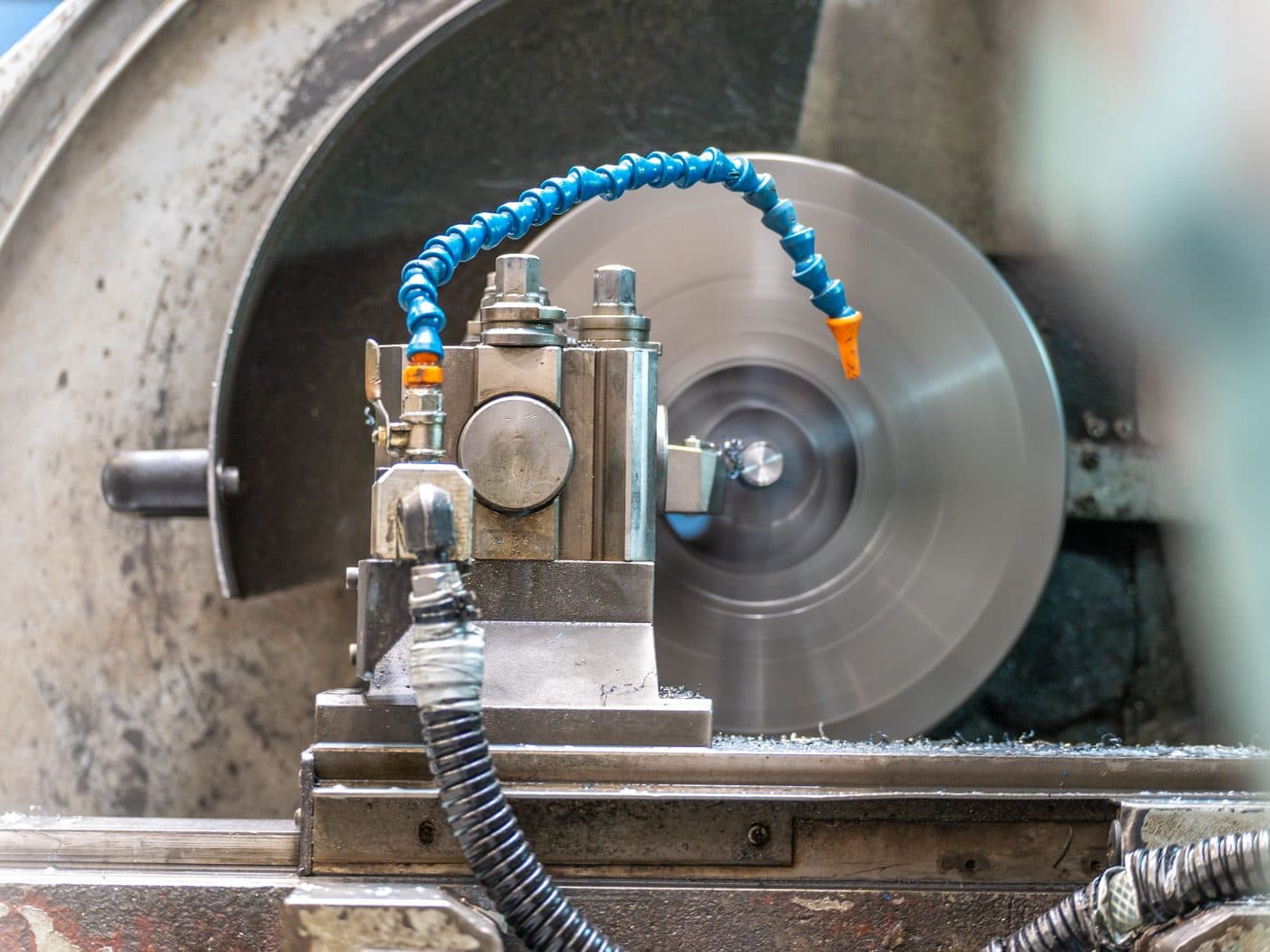 A precision grinding machine running with coolant
