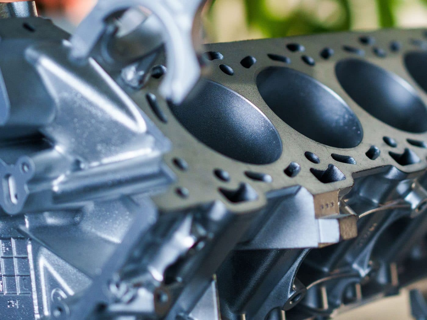 Close-up of a bare engine block deck and cylinder bores