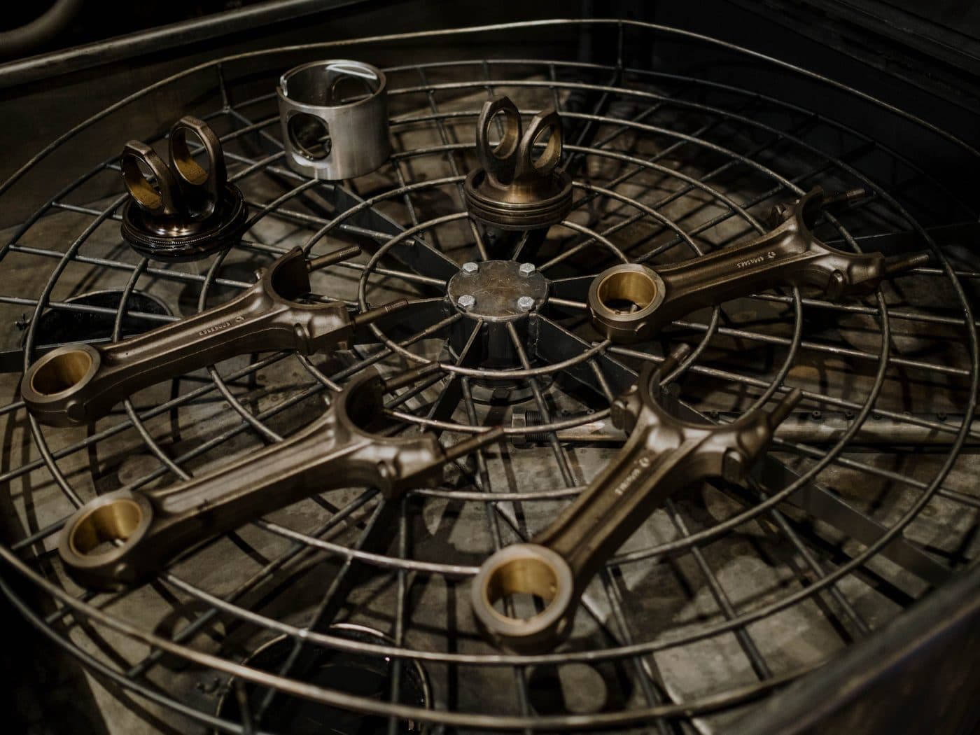 Engine parts laid out in a cleaning basket