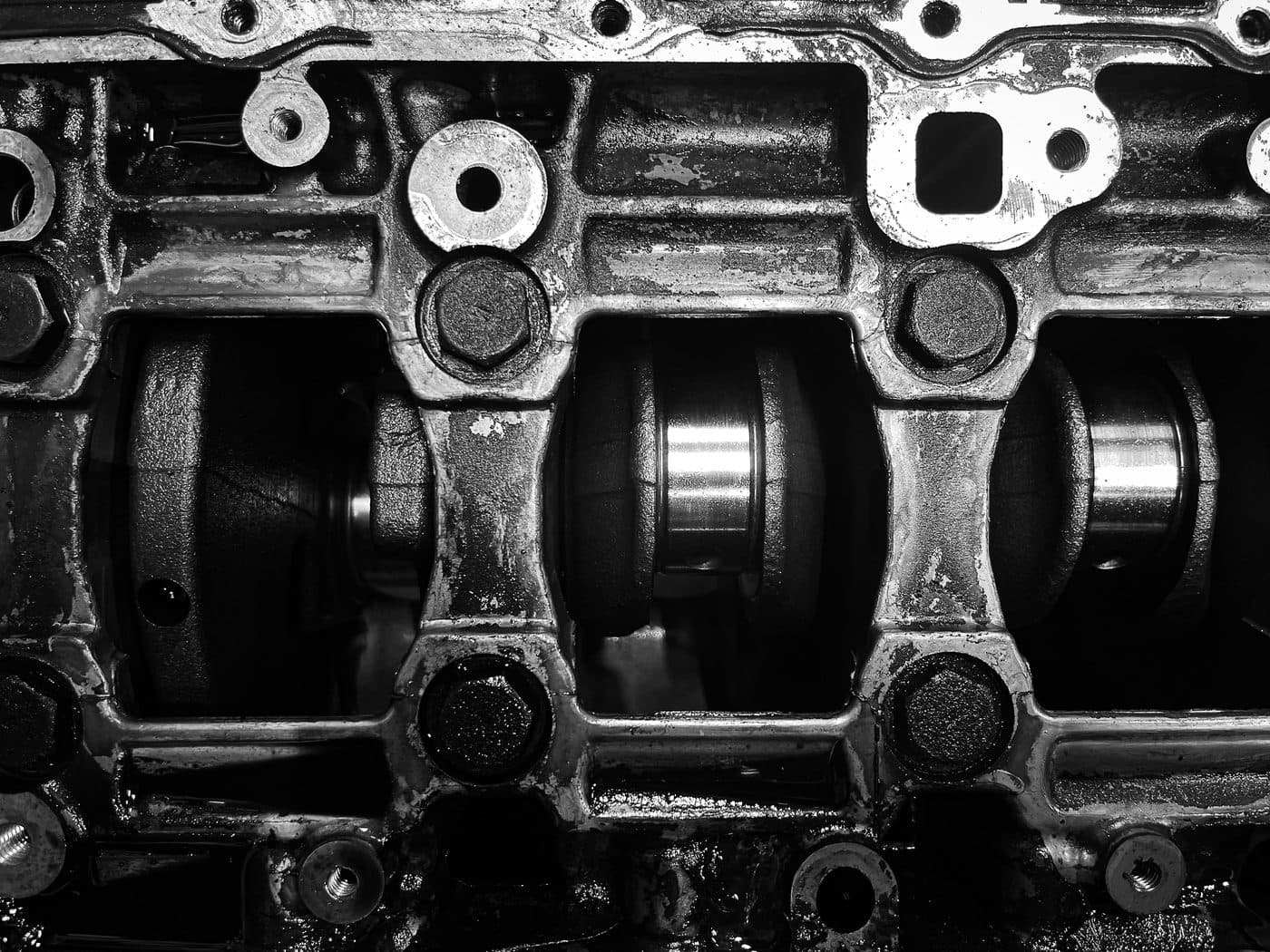 Black and white close-up of a crankshaft seated in an engine block