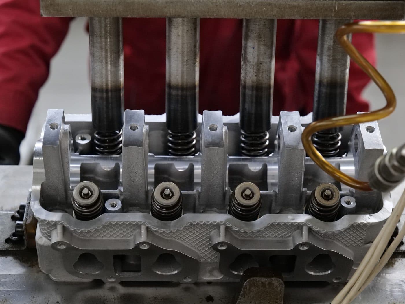 A cylinder head with its valves and springs during a valve job