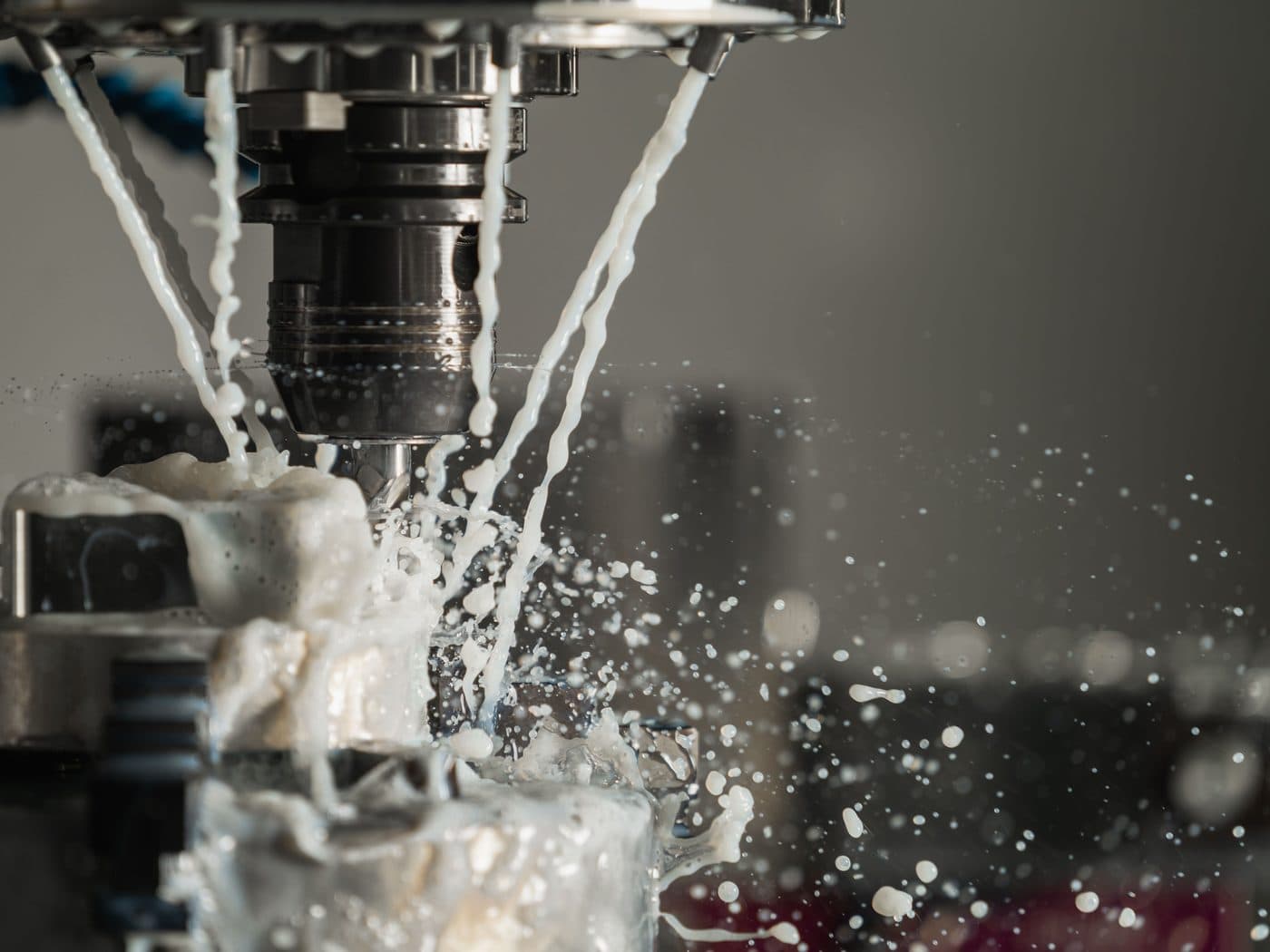 A milling cutter resurfacing metal under coolant spray